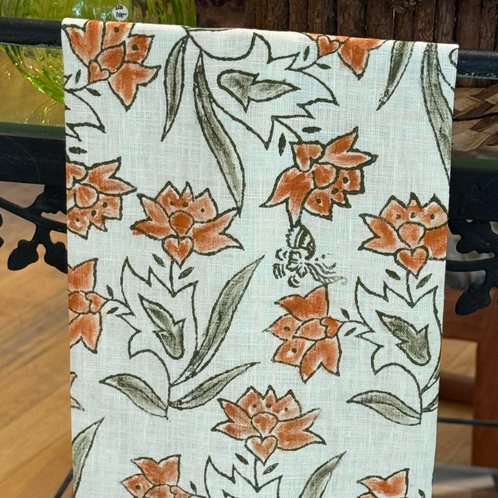 Floral patterned towel hanging on a glass table